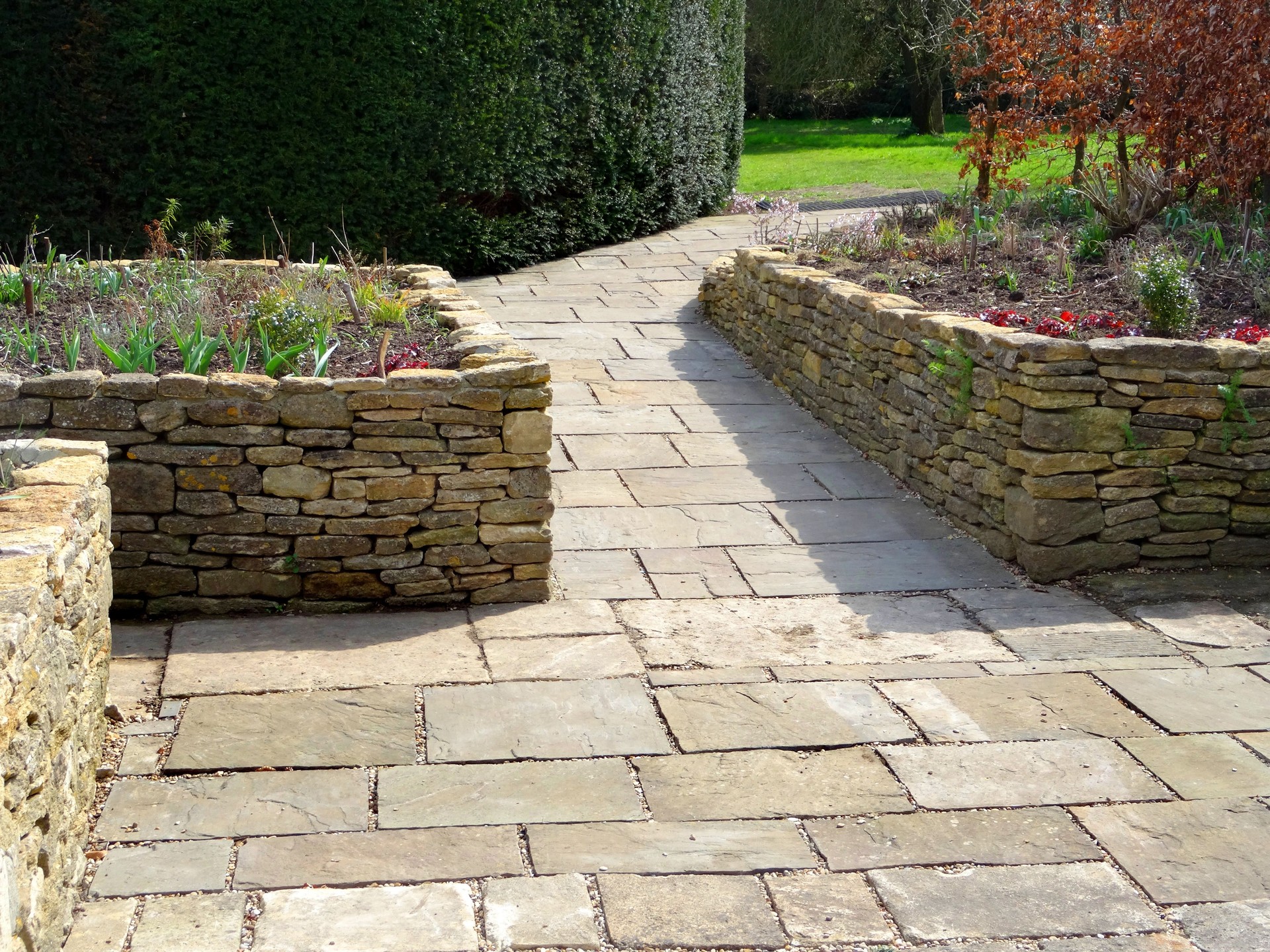 Image of raised garden beds with flagstone paving patio, wheelchair-friendly